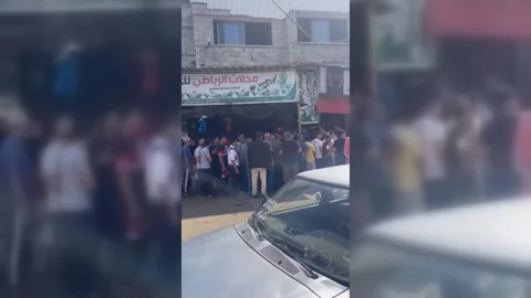 Gazans Queue For Dwindling Essentials Stock Footage 253192844
