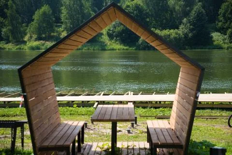 Gazebo by the river. a structure of unusual shape on the shore of a picturesq Stock Photos