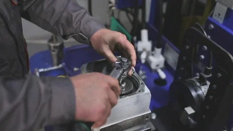 Gear assembly, gear assembly. Man tightens the nut Stock Footage 121410086