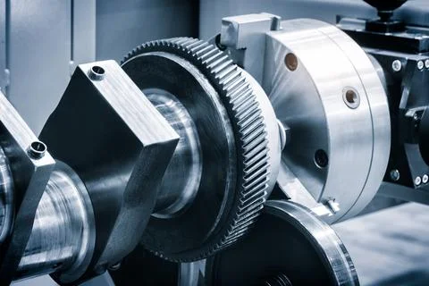 A gear is being worked on with a tool. Concept of precision and focus as the  스톡 사진