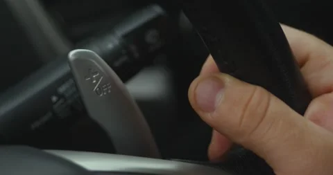 Gear levers in the steering wheel of a modern car. Paddle shift, car interior.	 Stock-Footage 162769658