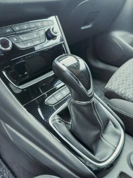 Gear shift and controls in a modern car interior during a sunny day drive e.. Stock Photos
