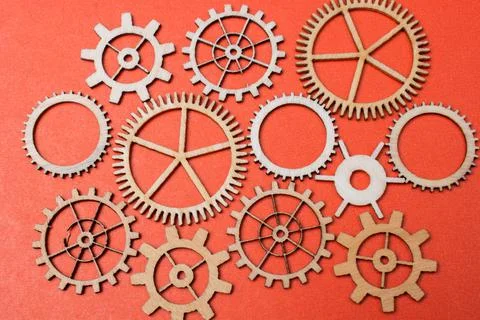 Gear wheels on red background as concept of engineering Stock Photos