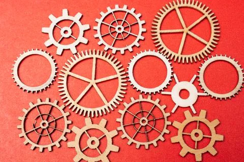 Gear wheels on red background as concept of engineering Stock Photos