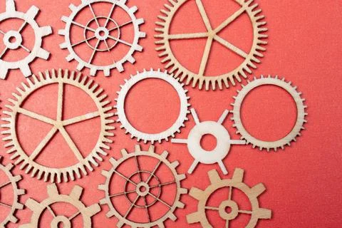 Gear wheels on red background as concept of engineering Stock Photos