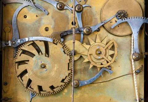 Gears and cogs in the clockwork of a historical pendulum clock, detail, regul Stock Photos