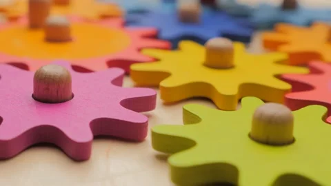 Gears and cogs macro in colorful wooden toy. Team work concept. Connection 動画素材 131618552