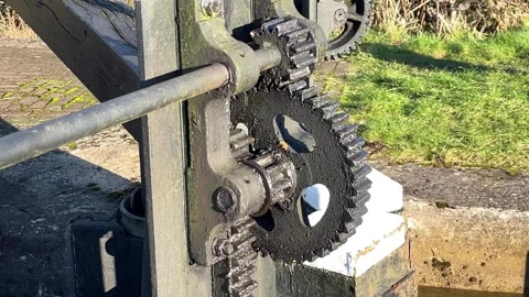 Gears cogs old industrial canal lock winding mechanism Stock Footage 298962389