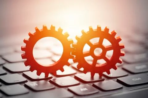 Gears on computer keyboard Stock Photos