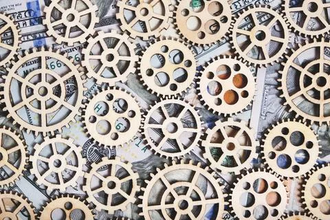 Gears different sizes against background hundred dollar bills, concept prog.. Stock Photos
