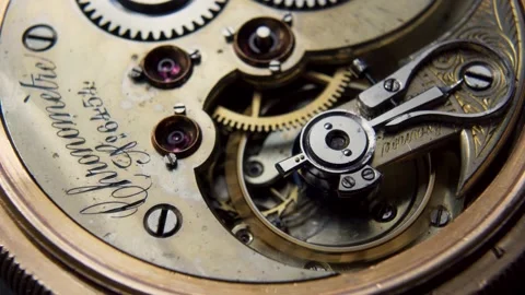 Gears turning inside the mechanism of an old pocket watch Stock Footage 153056078