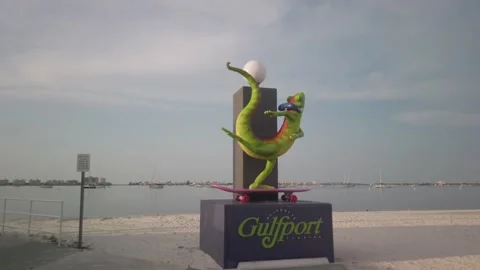 Gecko statue on skateboad on the beach near the Historic Gulfport Casino. Stock Footage 249132389