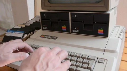 Ged Apple computer and hand insert floppy inside then  typing on keyboard Video stock 91186804