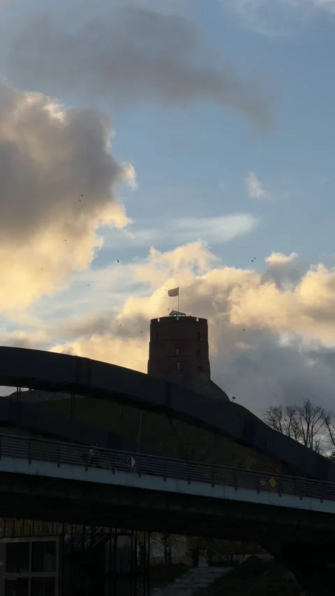 Gediminas Tower in Vilnius against dramatic sunset sky with golden clouds Stock Footage 294255372