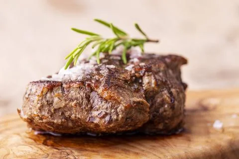Gegrilltes saftiges Steak auf Olivenholz grilled juicy steak on olive wood... Stock Photos