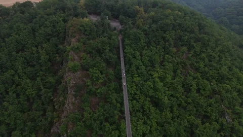 Geierlay suspension bridge running down steep rocky spur 스톡 동영상 340367934