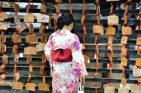 Geisha in front of prayer tablets Stock Photos