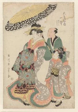 Geisha under parasol. A geisha walking to the left. A servant walks behind... Stock Photos