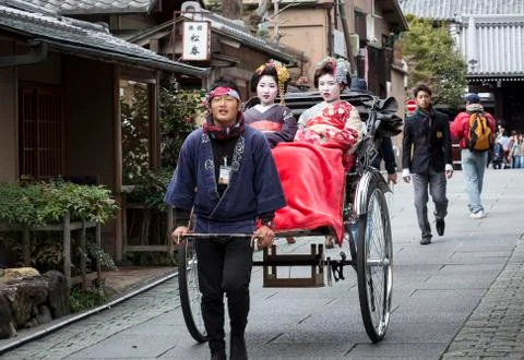 Geishas in a rickshaw Stock Photos