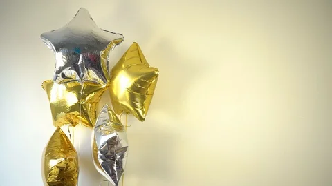 Gel-filled foil balloons, silver and gold stars Stock Footage 128192547