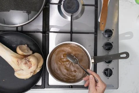 Gel to liquid bone broth: slow simmer transforms nourishment in a home kitc.. Stock Photos