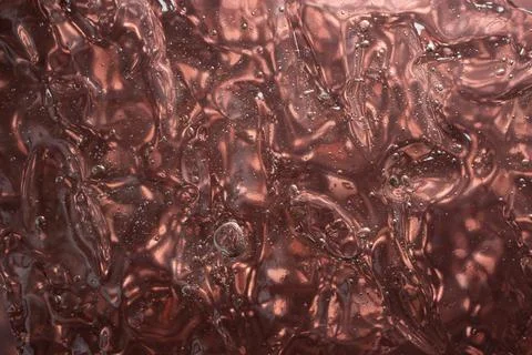 Gel structure on metallic brown  background, backdrop for cosmetic products.. Stock Photos