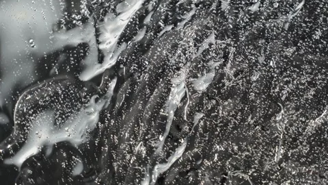 Gel texture on a mirror surface in motion Stock Footage 252195649