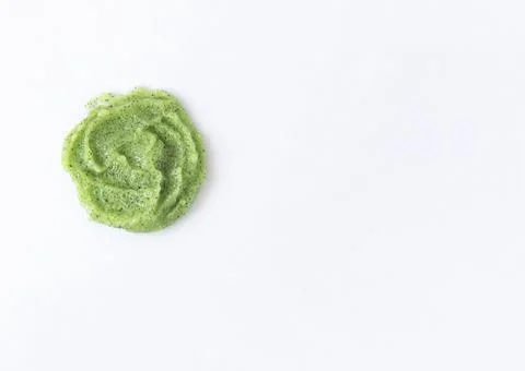 Gel texture with small particles of green scrub on a white background. Skin Stock Photos