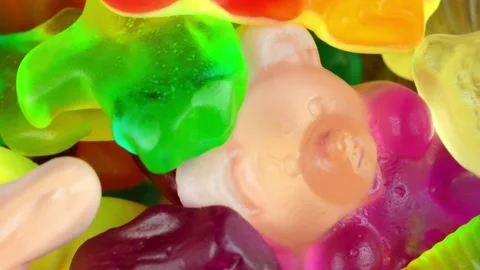 Gelatin sweets on a turning background. Flavour jelly shape. Concept of fruit Stock Footage 313481994