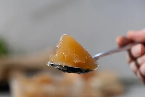 Gelled bone broth on spoon highlights collagen for beauty, skin, joints Stock Photos