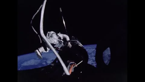 Gemini 12 astronaut Buzz Aldrin conducting extra-vehicular activity Stock Footage 263444605