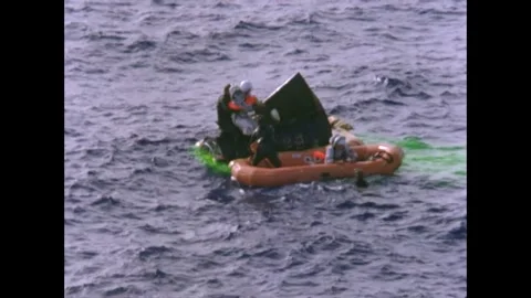 Gemini 7 capsule and astronauts floating in water during recovery Stock Footage 263445232