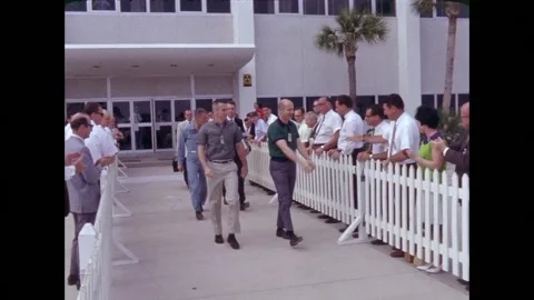 Gemini 9 crew Thomas P. Stafford and Eugene Cernan exiting a building Video stock 263445115