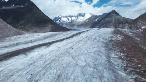Gemini said Aletsch Reveal: Reverse Drone Pullback of Icy Textures and Dark Stock Footage 332743542