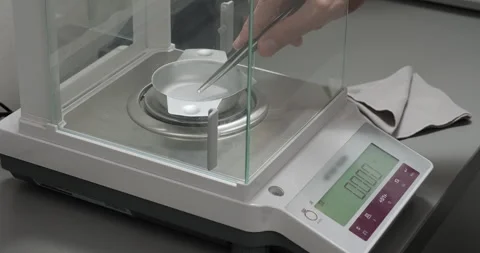 Gemmological laboratory. Gemologist weights diamond using electronic scale Stock Footage 247893814
