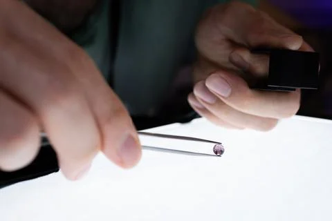A gemmologiste studying an amethyst Stock Photos