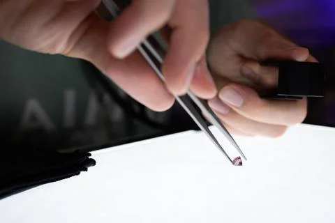 A gemmologiste studying an amethyst Stock Photos