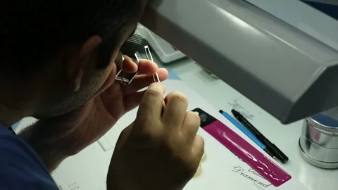 The gemologist checking the diamonds look at loop diamond Stock Footage 139662934