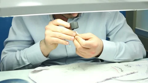 The gemologist checking the diamonds look at loop diamond. carat in workshop Stock Footage 139681785