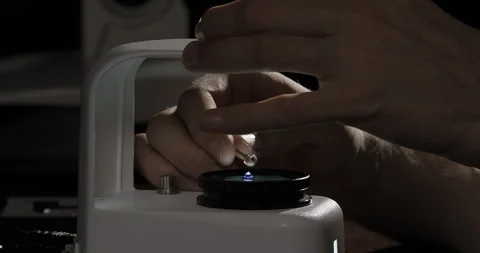 Gemologist checking sapphire gemstone to identify its grading and valuation. Gem Stock Footage 247896564