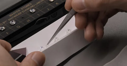 Gemologist checks diamond quality with master stones. Gemstone laboratory Stock Footage 260573521