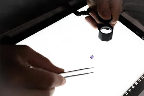 A gemologist inspects a gemstone Stock Photos