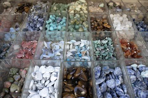 Gemstone pendants assortment in plastic boxes Stock Photos