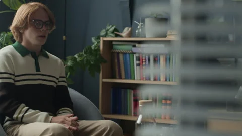 Gen Z Guy Answering Questions of Female Psychologist in Green Office Stock Footage 317823183