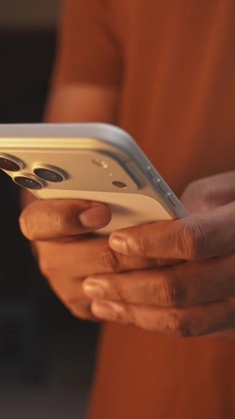 Gen Z hands using a smartphone in a light filled building interior, close up, Stock Footage 333280259