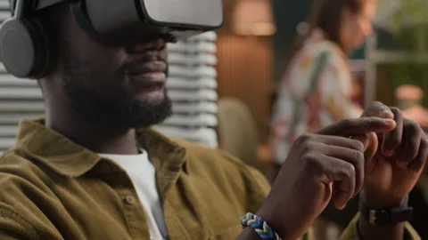 Gen Z Man Developing in AR Goggles Working with Colleague Coding in Background Stock Footage 302893314