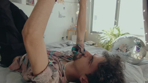 Gen Z Man Resting on Bed and Doing Hand Dance Stock-Footage 235656833