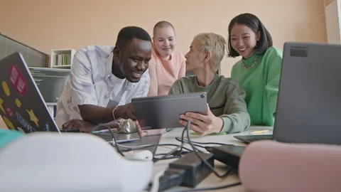 Gen Z Students Using Tablet and Talking on Programming Lesson Stock Footage 257061081