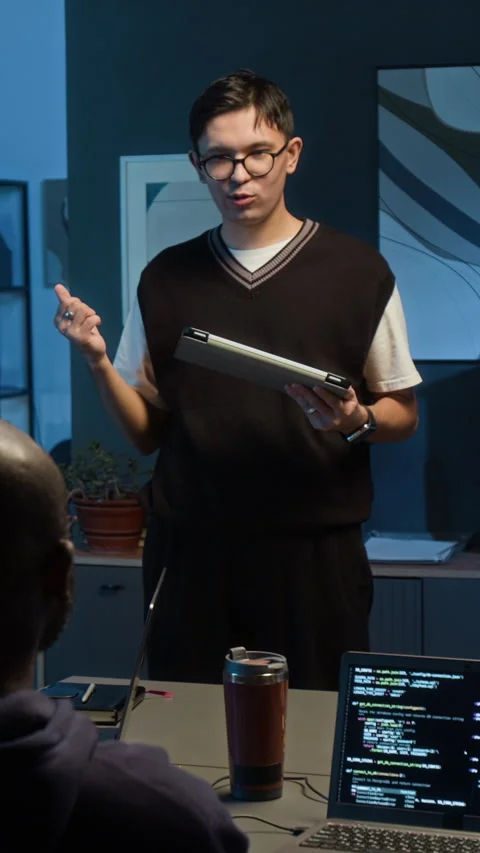 Gen Z Tech Specialist with Tablet Suggesting Solutions Standing in Dark Office Stock Footage 329618471