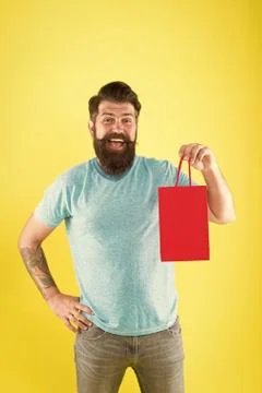 Gender differences in purchase decision making. Happy hipster hold paper bag Stock Photos